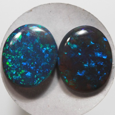 SOLID BLACK OPALS Matching pair. Bright green sparkles constantly
